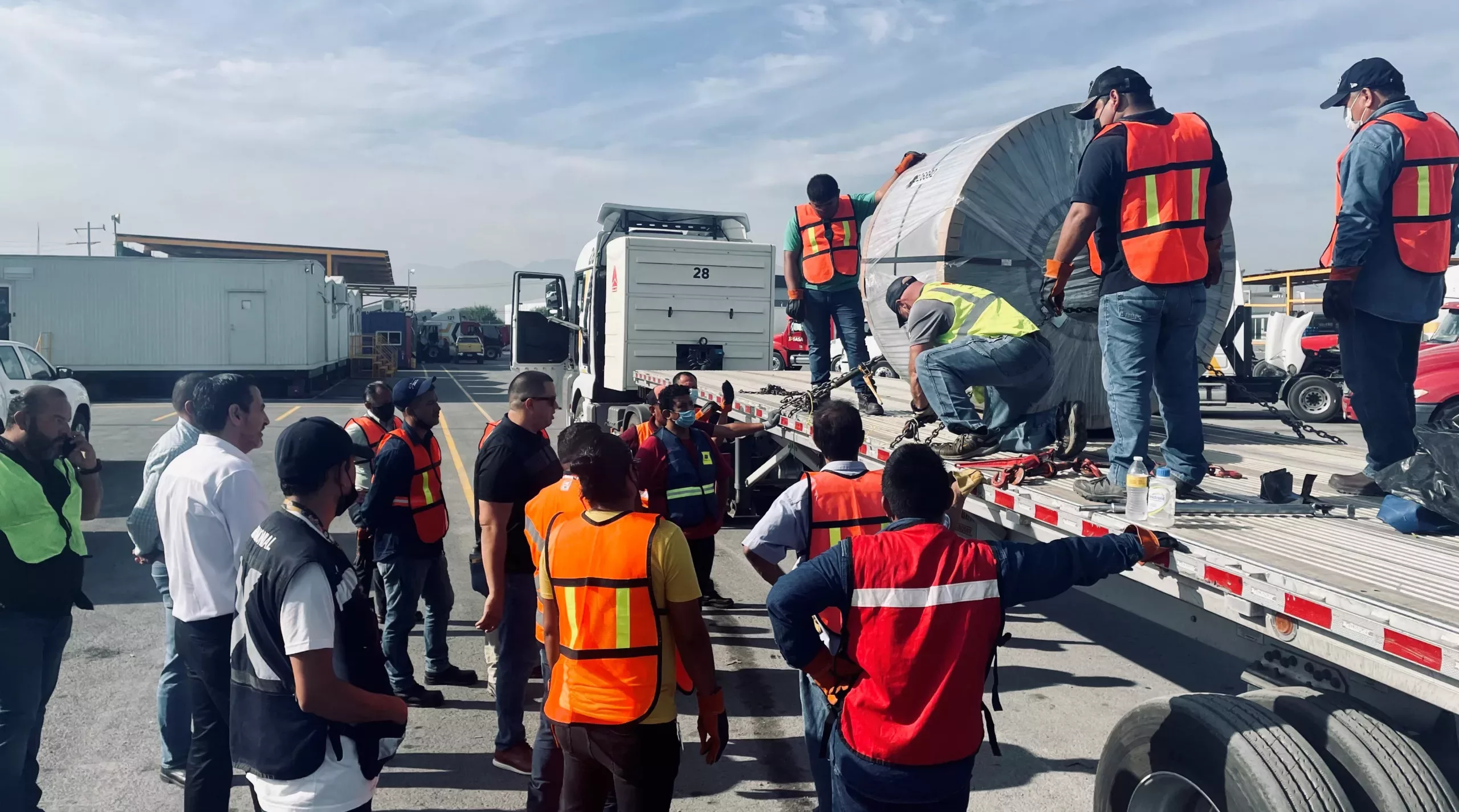 Men working with a truck and high visibility clothing.